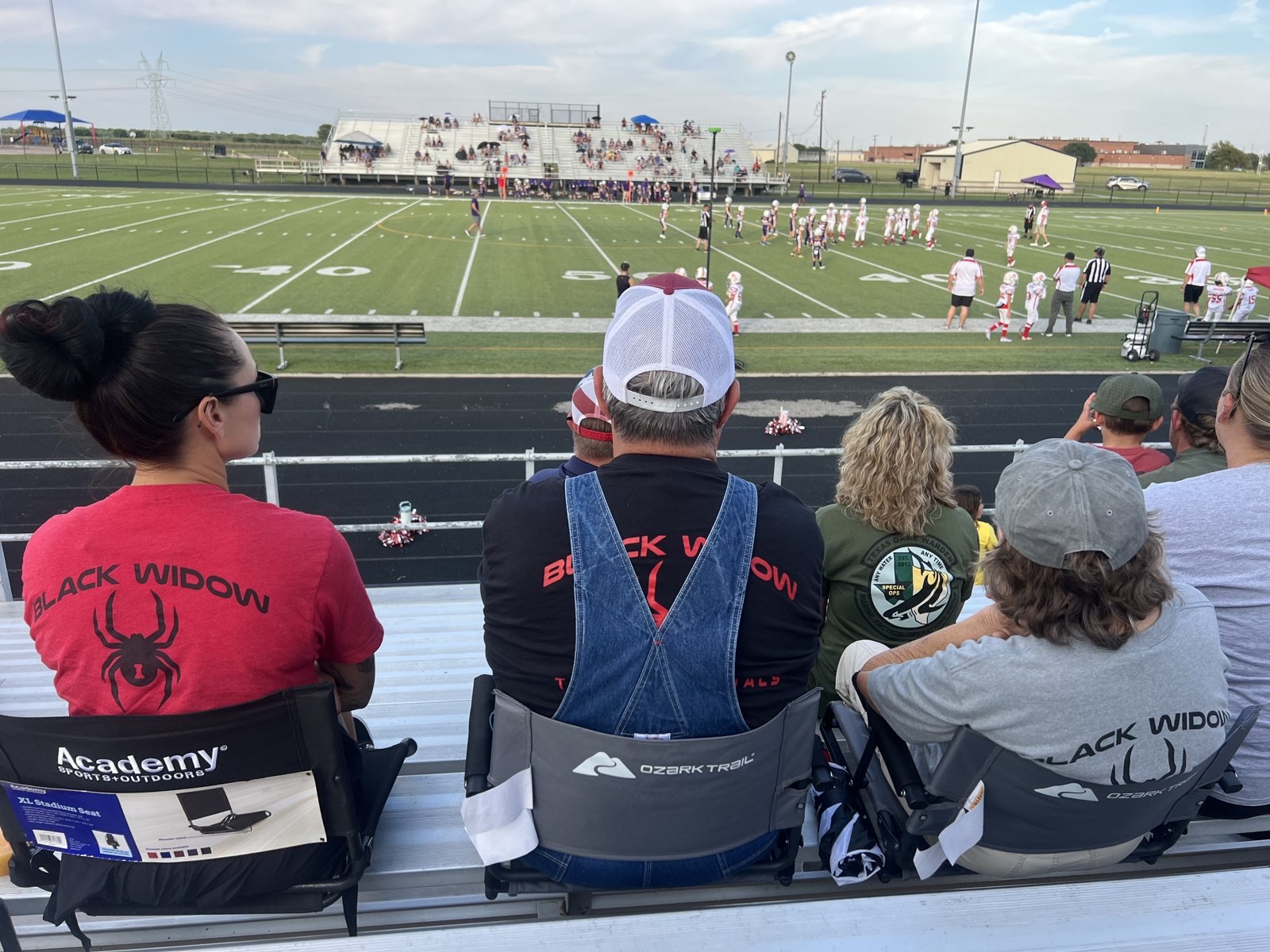 The Black Widow Trailer Rentals family and community in Black Widow gear at a local Caddo Mills football game